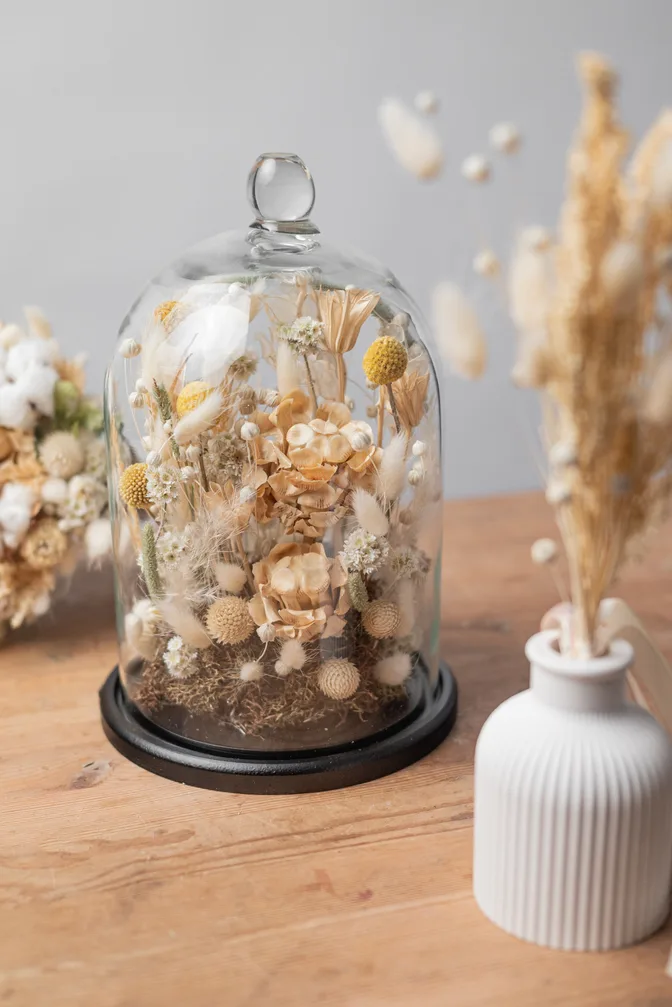 Dried flower composition under a glass cloche