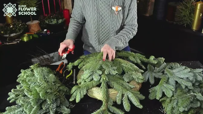 Short-needled fir branches prepared beside a wreath base