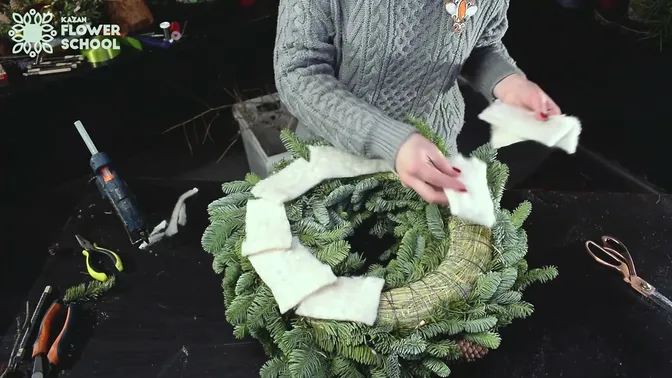 Fabric covering the exposed hay and wire on the back of the fir wreath