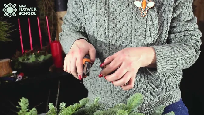 Cutters trimming the wire fixing on a pinecone