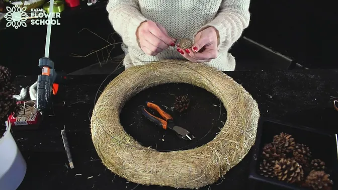 Pinecones, wire and a hay wreath ring before assembly