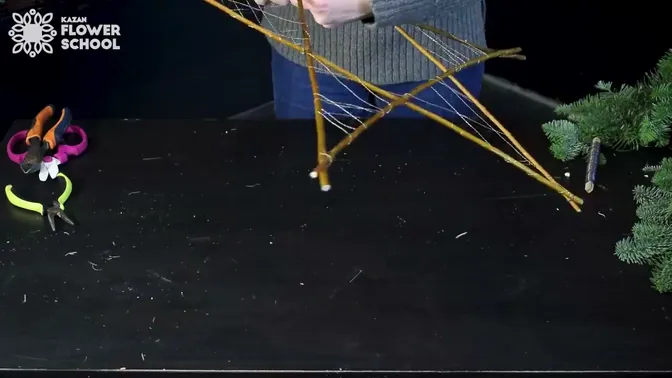 Fine gold-colored wire stretched across the triangular points of the twig star.