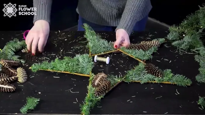 Split cones wired over fir on the five twig points.