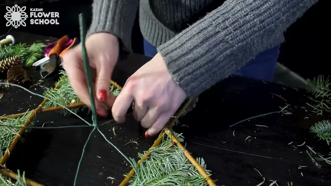 Taped green wires spreading from the center toward the back of the fir-covered star.