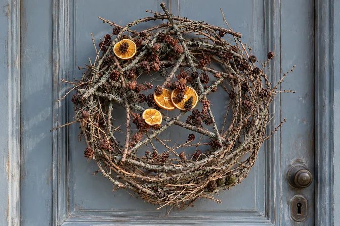 An open branch wreath with a twig star and dried citrus