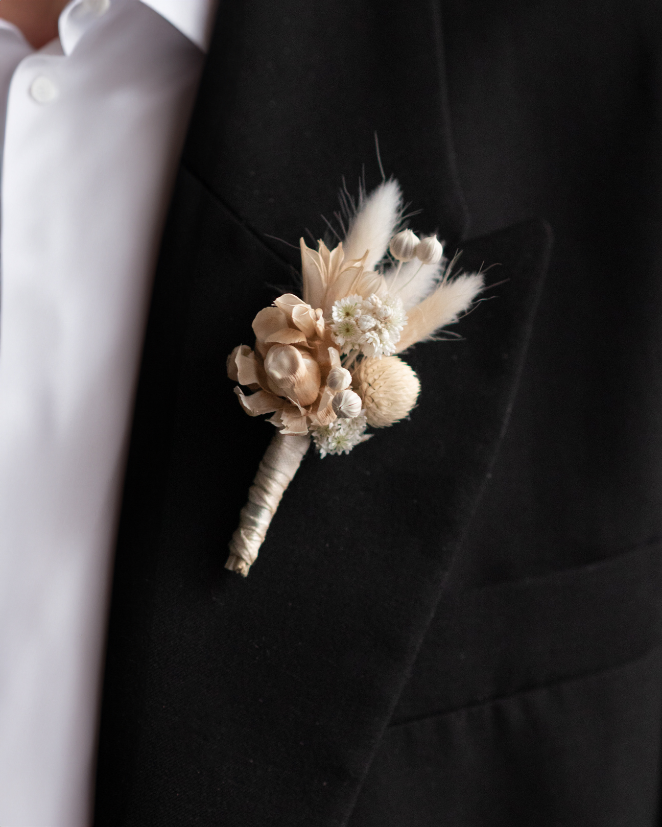Dried flower boutonniere pinned to a jacket