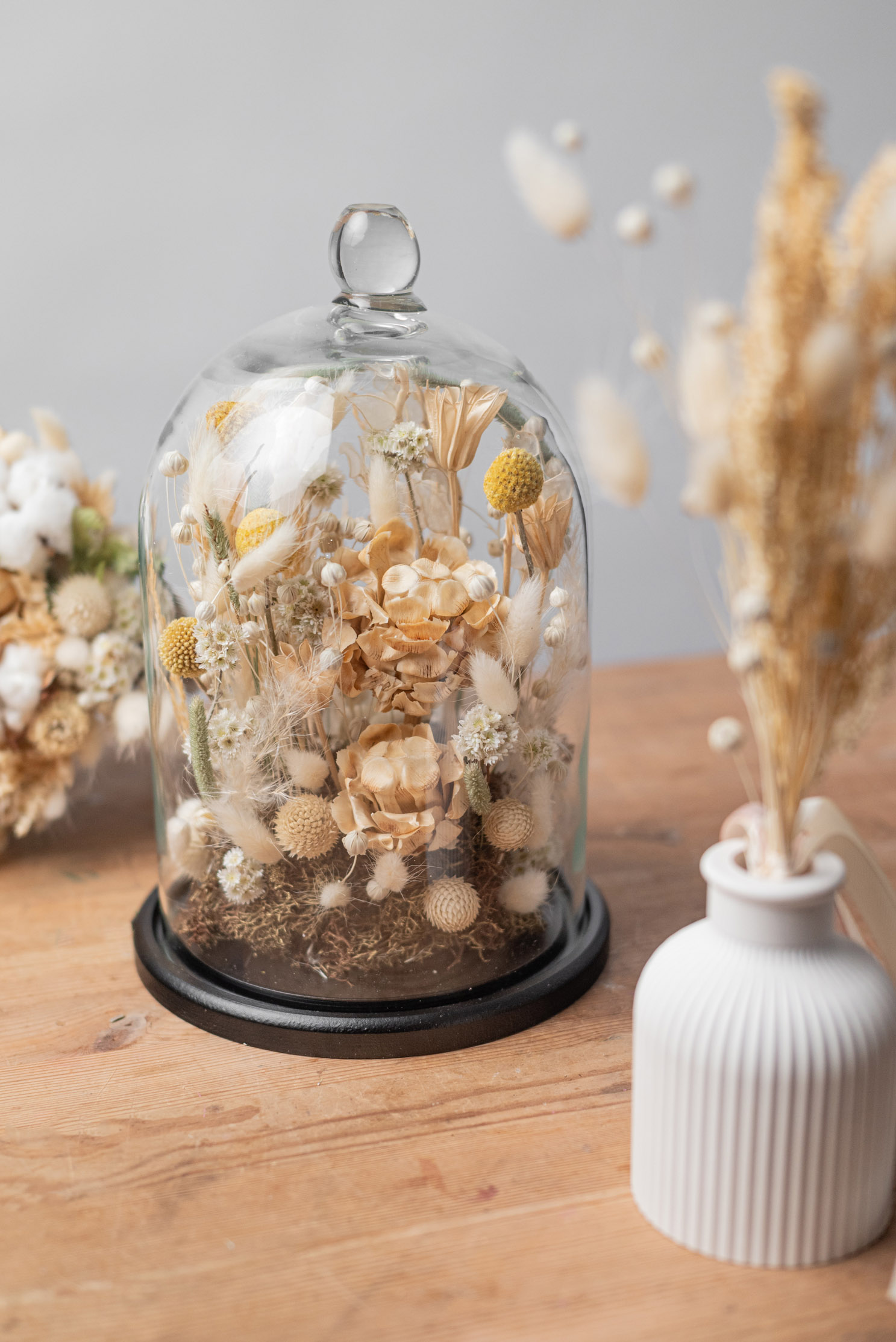 Dried flower composition under a glass cloche